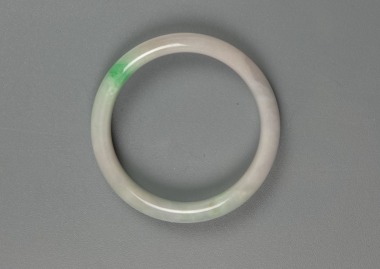 A Green And Light Lavender Jadeite Bangle.