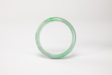 A Green Jadeite Bangle.