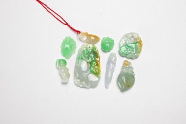 A Group Of Eight Jadeite Pendants