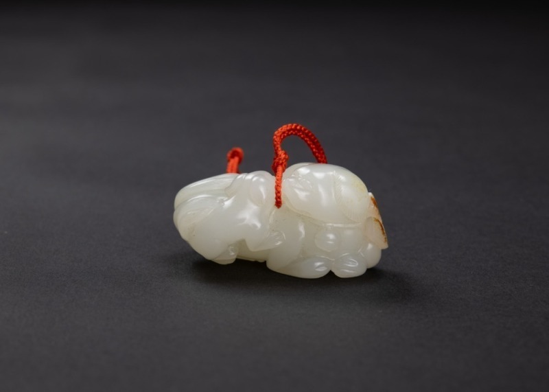 A Fine Russet White Carved &lsquo; Two Lions&rsquo; Pendant.