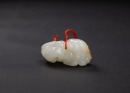 A Fine Russet White Carved &lsquo; Two Lions&rsquo; Pendant.