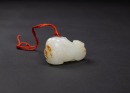 A Fine Russet White Carved &lsquo; Two Lions&rsquo; Pendant. - 2