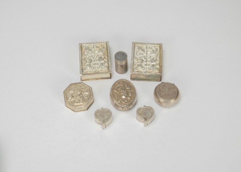 A Group of Eight Chased Silver Rouge Boxes,
