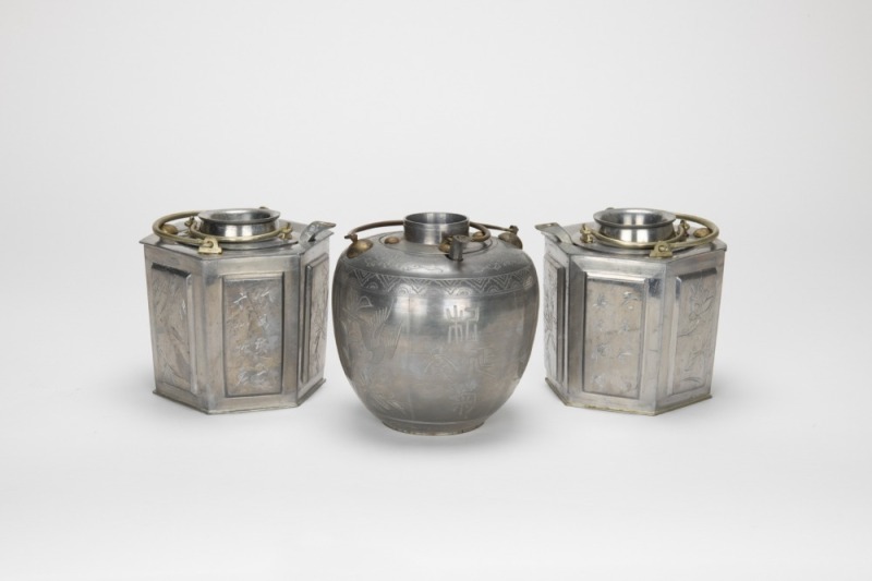 A Group Of Three Tin Win Warm Pot.
