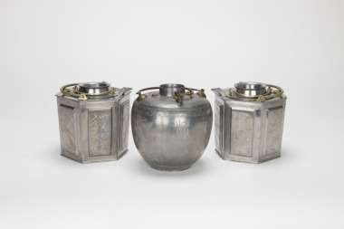 A Group Of Three Tin Win Warm Pot.