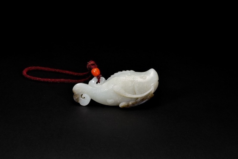 A White Jade Carved &lsquo;Carp with Lotus&rsquo; Pendant. LateQing/Republic