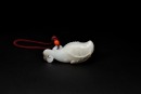 A White Jade Carved &lsquo;Carp with Lotus&rsquo; Pendant. LateQing/Republic